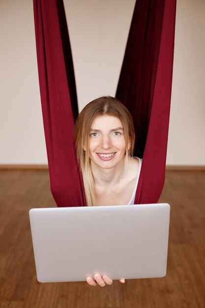 Young woman practicing yoga in her room