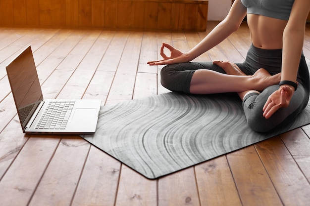 Young woman practicing yoga at home