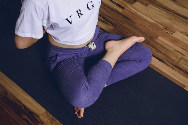 Young woman practicing yoga in home.