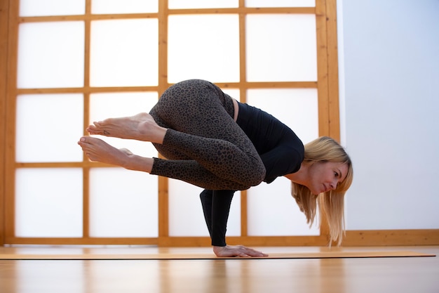 Young woman practicing yoga in a Japanese style room