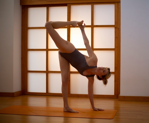 Young woman practicing yoga in a Japanese style room