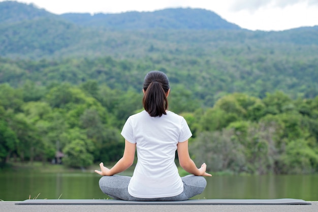 Young woman practicing yoga in the nature. Meditation.