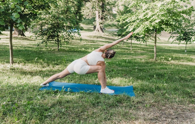 Молодая женщина упражнениями йоги на открытом воздухе