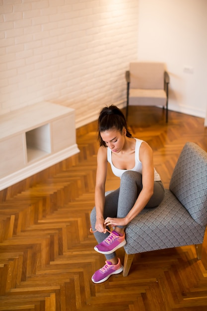 Young woman preparing for exercise at home