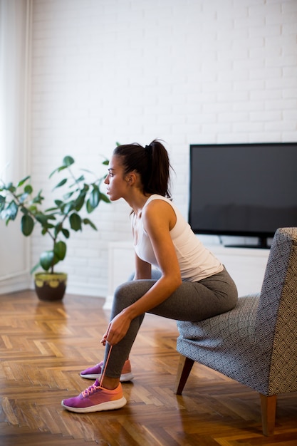 Young woman preparing for exercise at home