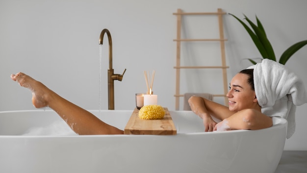 Photo young woman preparing for her bath time