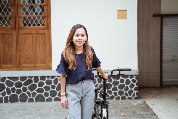 Young woman preparing her folding bike