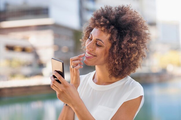 Young woman preparing for selfie, checking make up