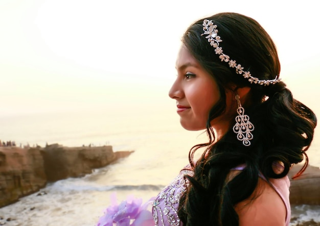 Young woman in a princess costume and a bouquet of flowers in her hand.