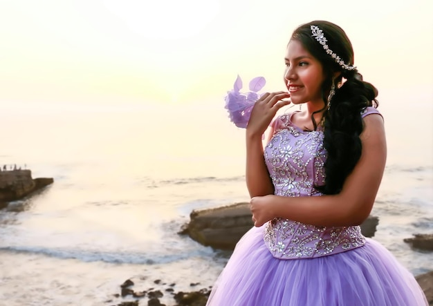 Young woman in a princess costume and a bouquet of flowers in her hand.