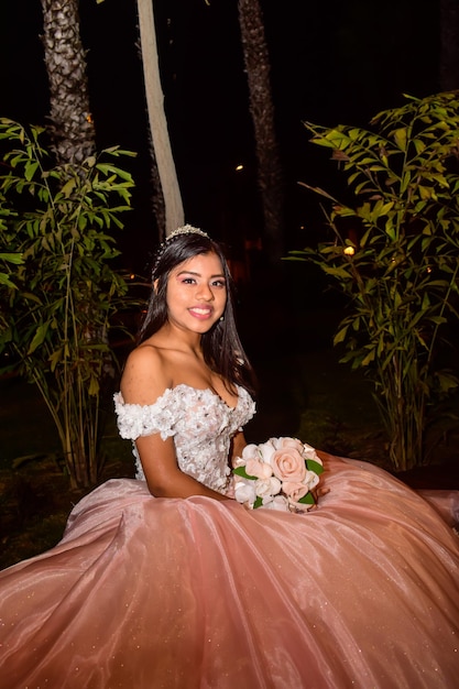 Young woman in princess costume, crown and a bouquet of flowers in her hand.