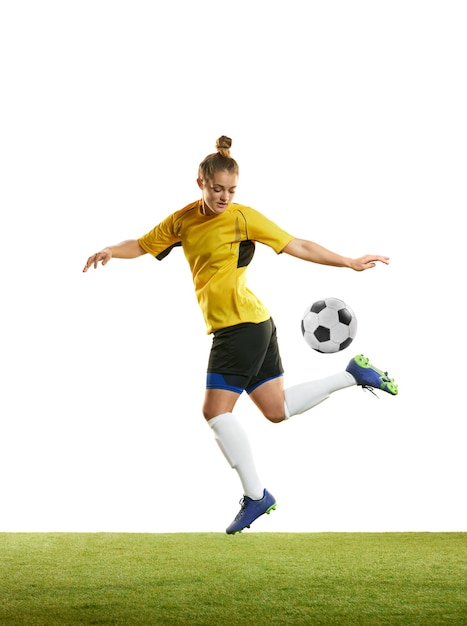 Young woman professional female football player in motion training playing football soccer isolated