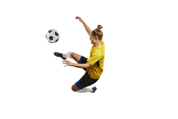 Young woman professional female football soccer player in motion training playing isolated over