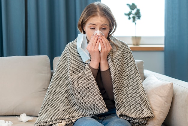 Young woman in protective sterile medical mask indoors