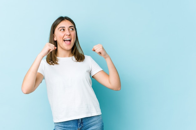 Young woman raising fist after a victory, winner concept