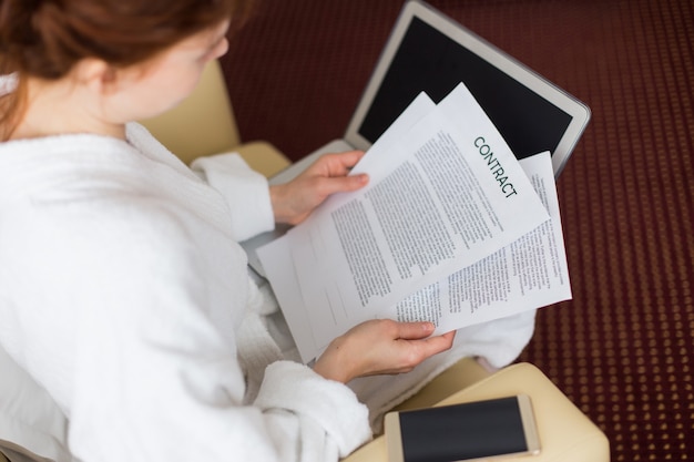 Young Woman Reading Contracts During Business Trip