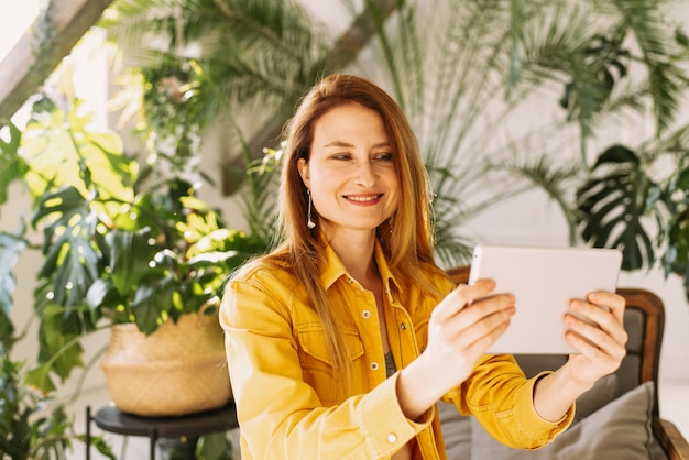 Young woman reading e-book on the couch