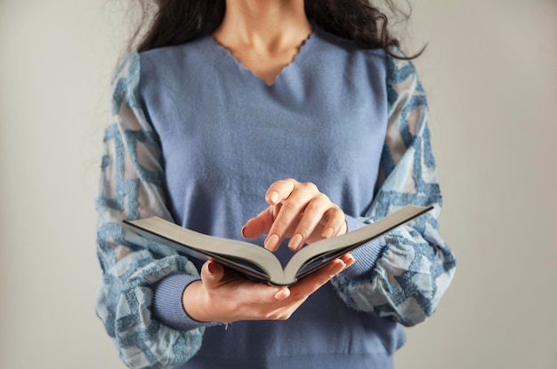 Young woman reading Holy Bible