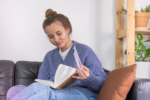 A young woman reads letters from her friend. a woman enjoys\
reading letters.