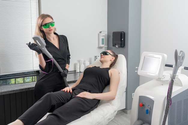 Young woman receiving laser treatment in cosmetology clinic