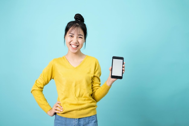 Young woman recommends downloading an application showing the smartphone screen