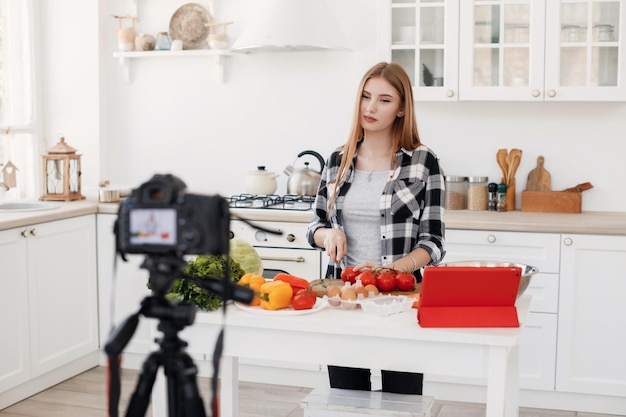 young woman recording online course for cooking