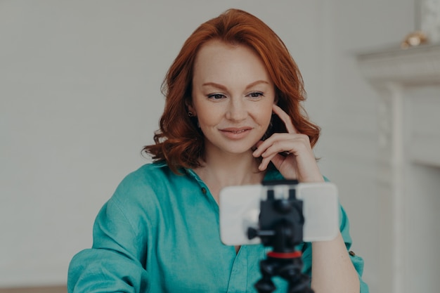 Young woman recording a video on smartphone