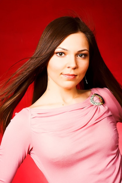 Young woman over red background