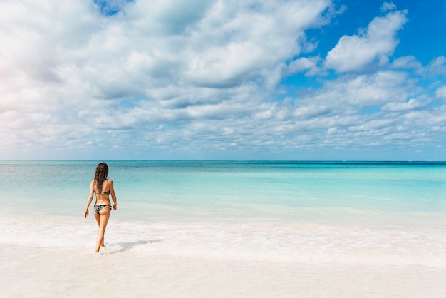 Young woman relax on the beach. Holidays Concept.