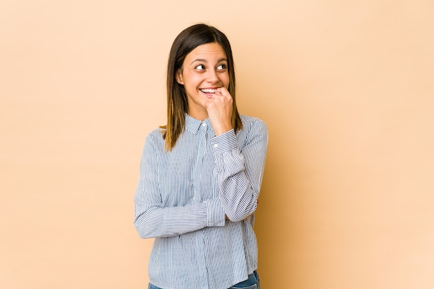 Young woman relaxed thinking about something looking at a copy space.