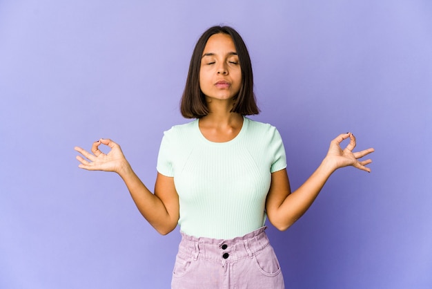 Young woman relaxes after hard working day, she is performing yoga