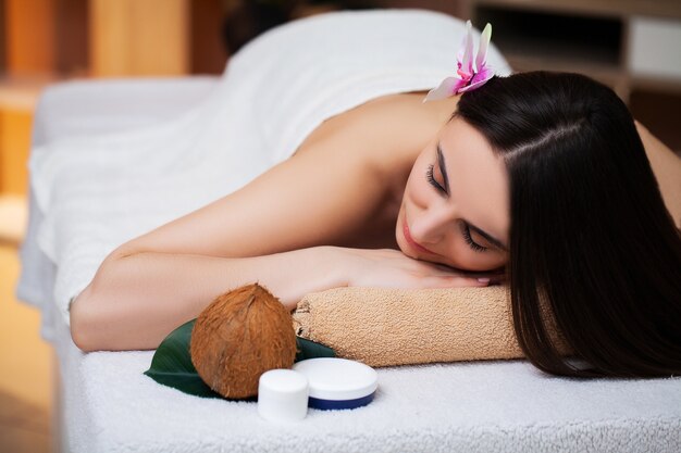 Young woman relaxes during spa treatments in beauty studio