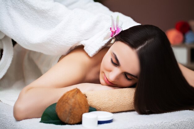 Young woman relaxes during spa treatments in beauty studio