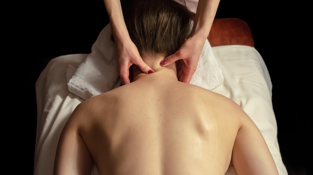 Young woman relaxes on thai massage close up