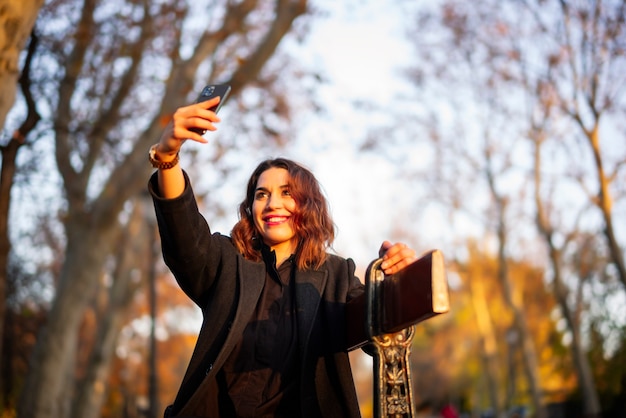 Young woman relaxing in the autumn park