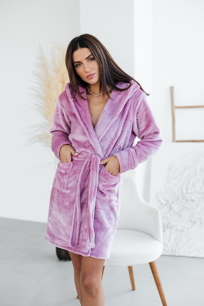 Young woman relaxing in bathrobe and spa towel after having bath shower treatment rest and body care