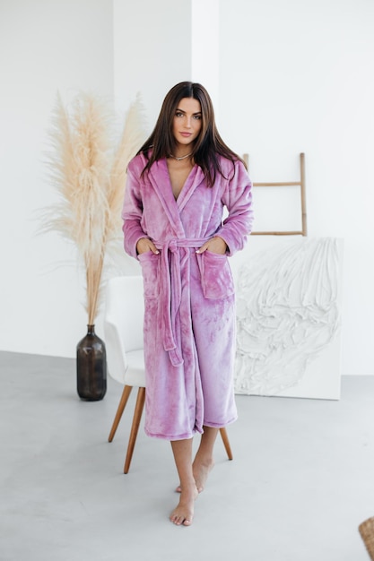 Young woman relaxing in bathrobe and spa towel after having bath shower treatment rest and body care