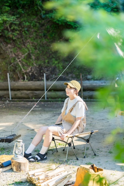 Young woman relaxing at a campsite on fine day