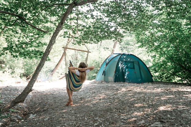 A young woman relaxing in a hammock.