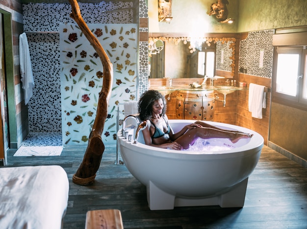 Young woman relaxing in the hydro massage bath