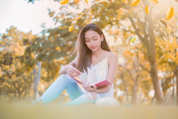 Young woman relaxing in the natural park. Vacation on Autumn season.