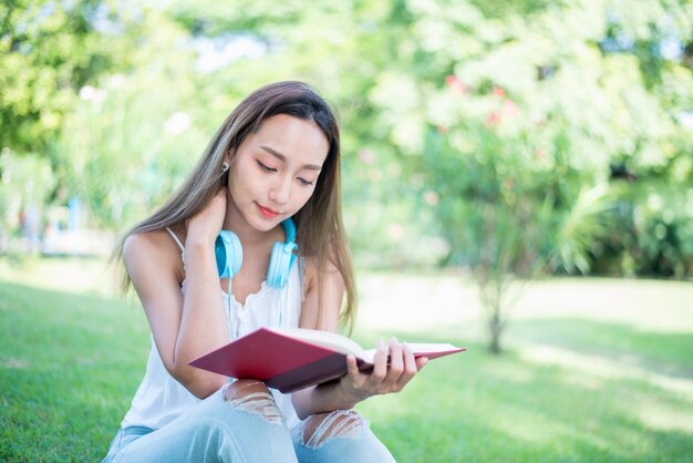 Young woman relaxing in the natural park. Vacation and freedom holiday in the garden.