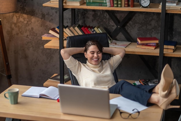 A young woman relaxing in the office after work