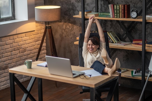 A young woman relaxing in the office after work