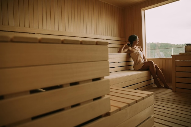 Young woman relaxing in the sauna