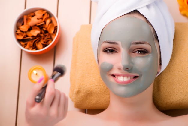 Young woman relaxing in spa in health concept