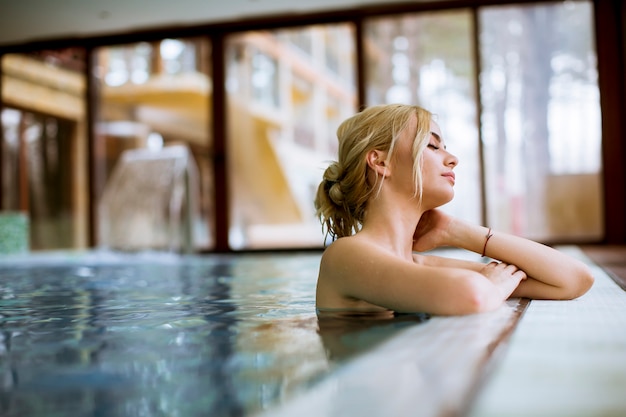 Young woman relaxing in spa swimming pool