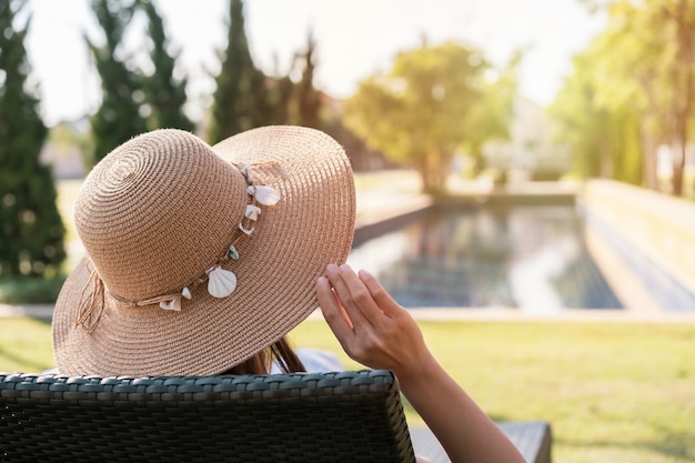 Young woman relaxing at swimming pool