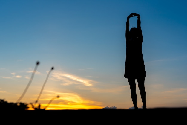 Young woman relaxing with sunset