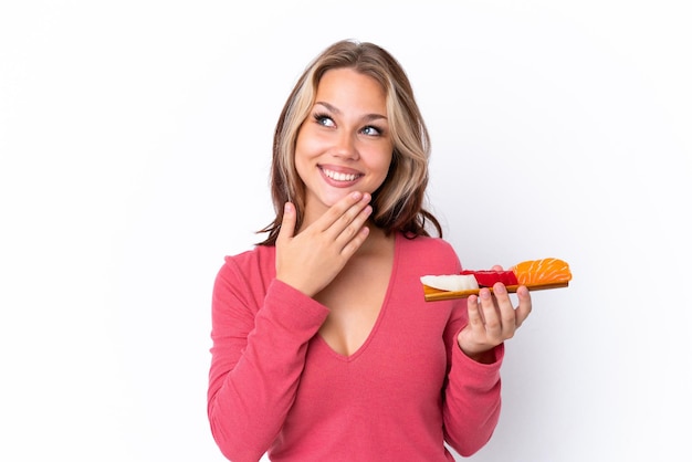 Young woman removing makeup from her face with cotton pad